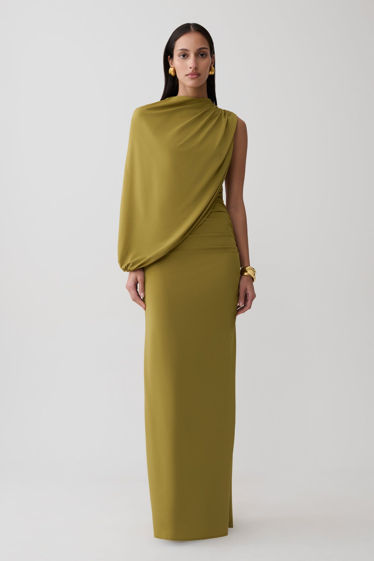 Woman wearing a green gather sleeve maxi dress.
