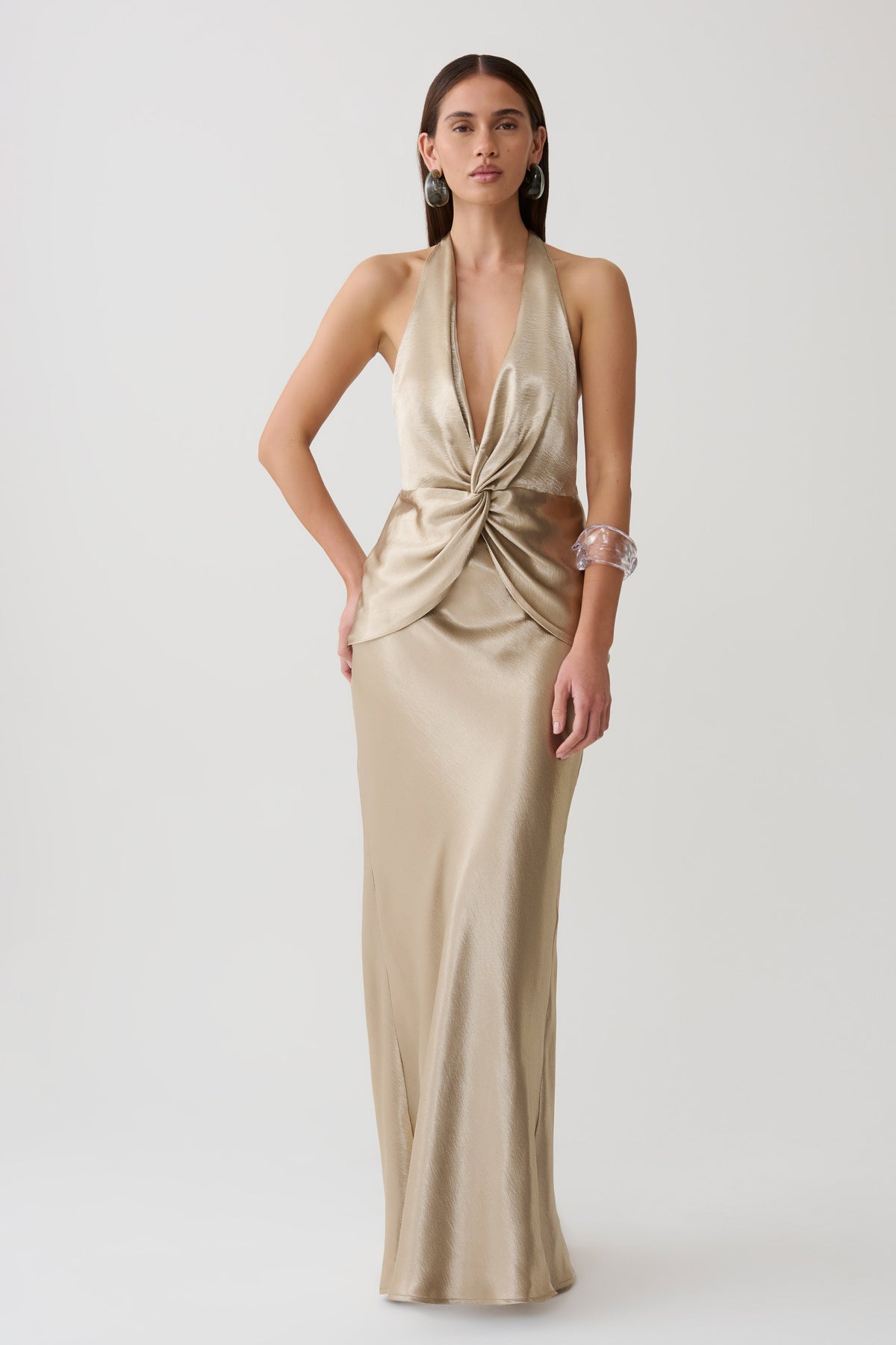 Woman wearing a gold neck satin maxi dress.