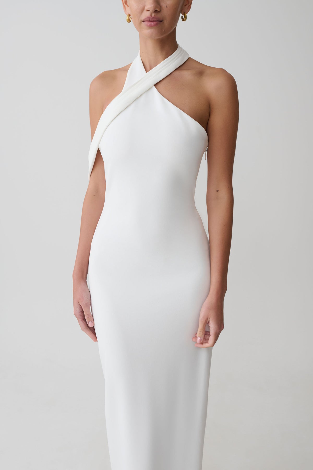 Woman wearing white crossover neck dress.