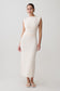 Woman wearing a white ruched modal sleeveless midi dress.
