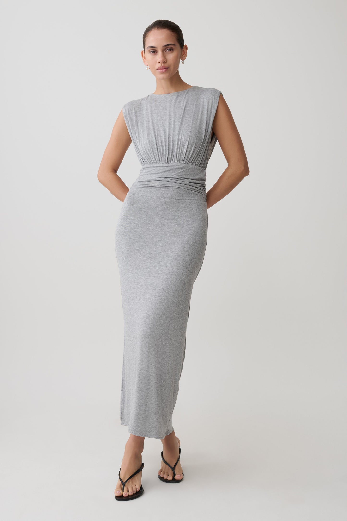 Woman wearing a grey ruched modal sleeveless midi dress.
