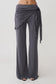 Woman wearing straight leg pants with waist wrap.