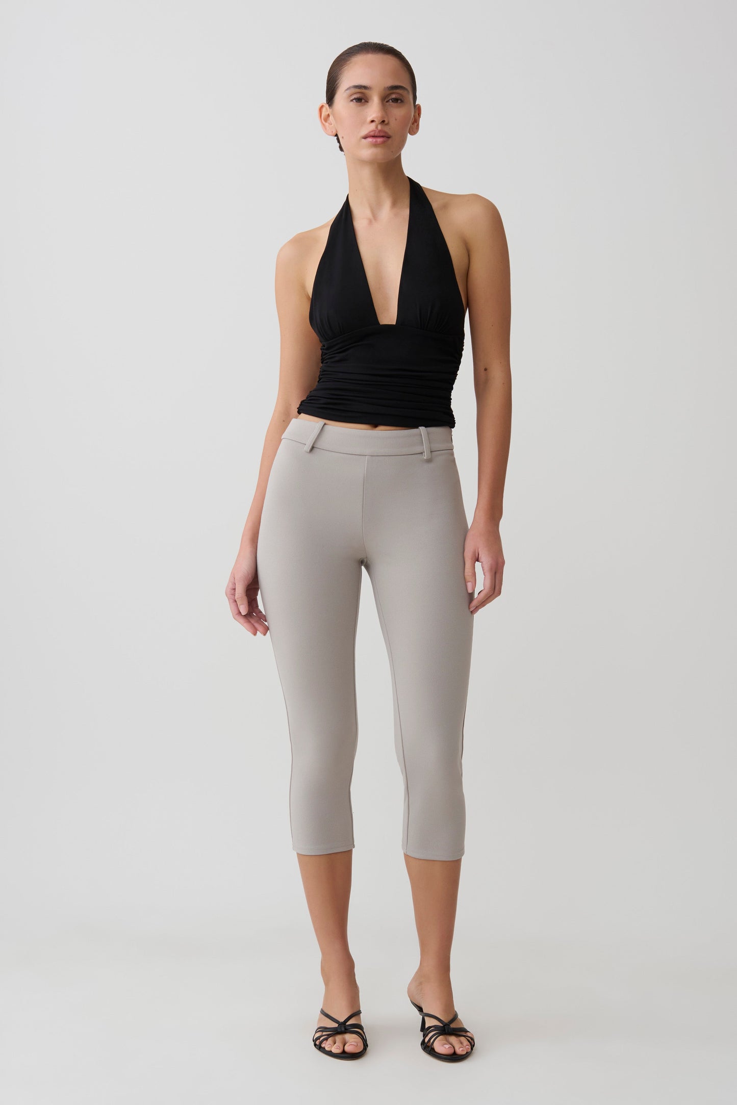 Woman wearing stretch crepe capri pants.