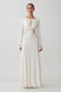 Woman wearing a white lace slinky maxi dress.