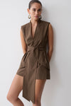 Woman wearing a brown striped waist tie sleeveless top.