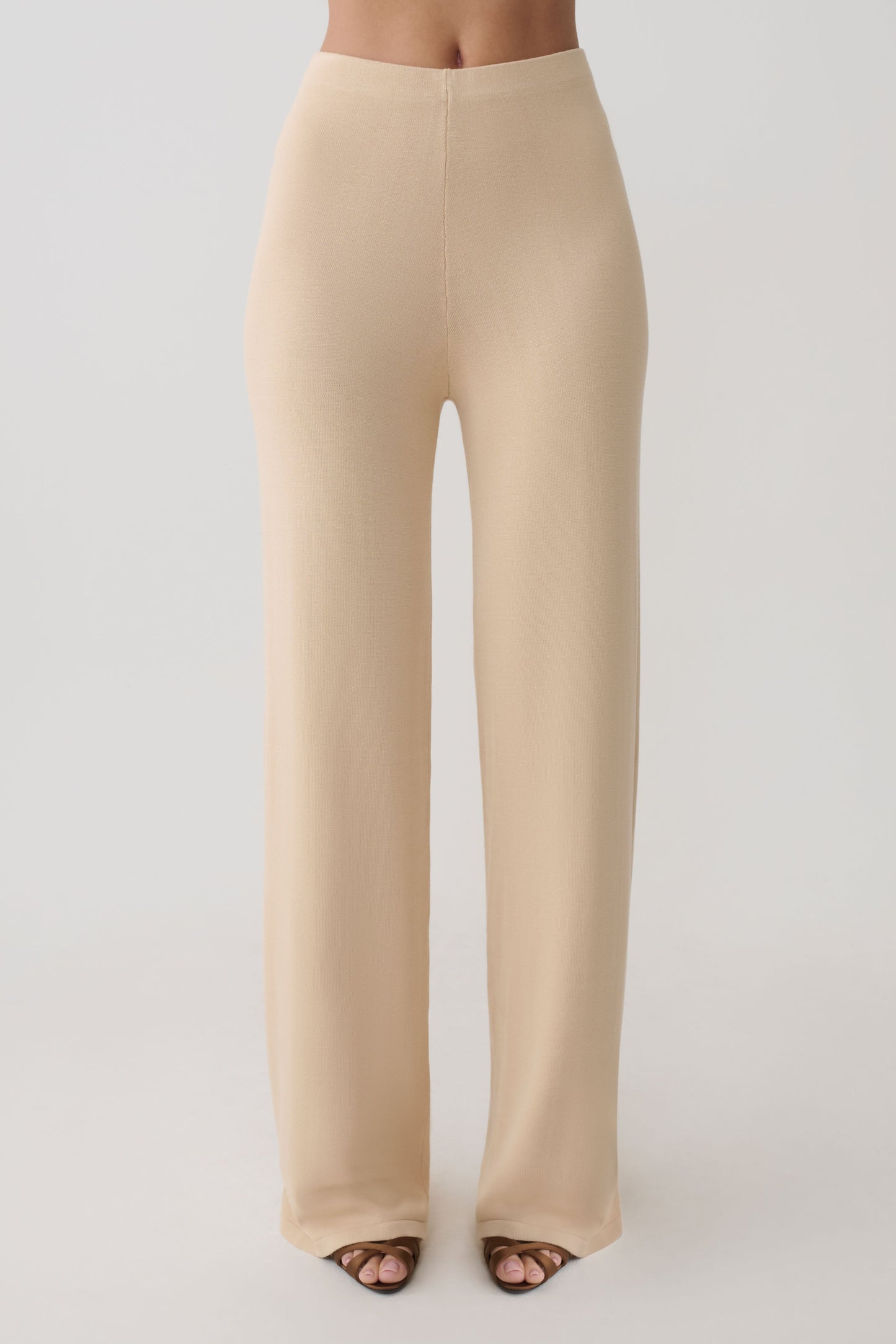 Woman wearing beige knit pants.