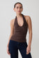 Woman wearing a brown ruched halter top.