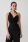Woman wearing a black halter neck asymmetrical top.