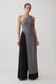 Woman wearing a grey long line top with front cut out.