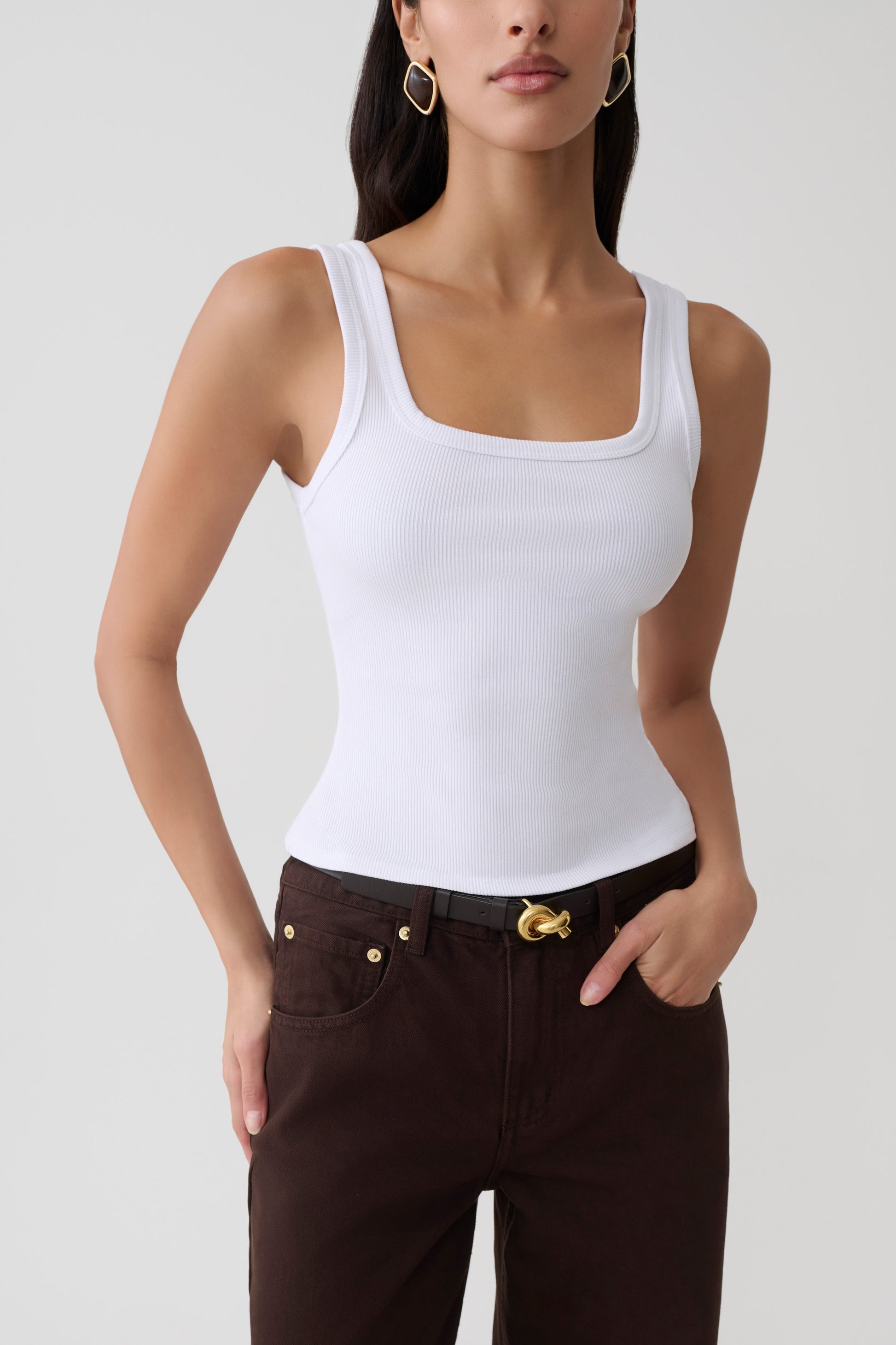 Woman wearing white square neck tank.