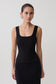 Woman wearing a black square neck tank.