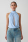 Woman wearing a blue viscose sleeveless halter top.