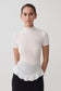 Woman wearing a white short sleeve ruffle top.