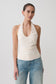 Woman wearing a white ruched halter top.