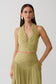 Woman wearing a green gathered v neck top.