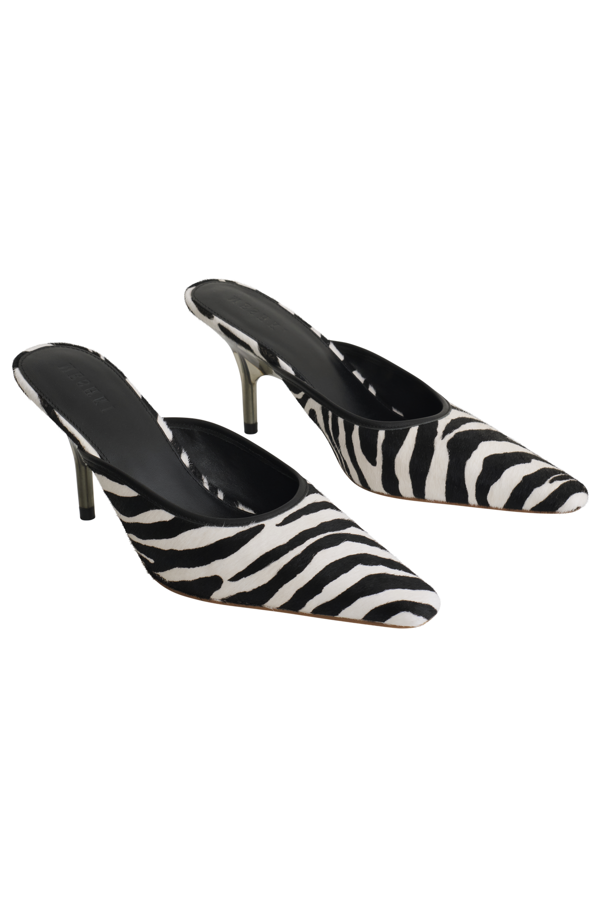A pair of pointed-toe mule heels with a black and white zebra print pattern, shown against a plain white background.