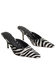 A pair of pointed-toe mule heels with a black and white zebra print pattern, shown against a plain white background.