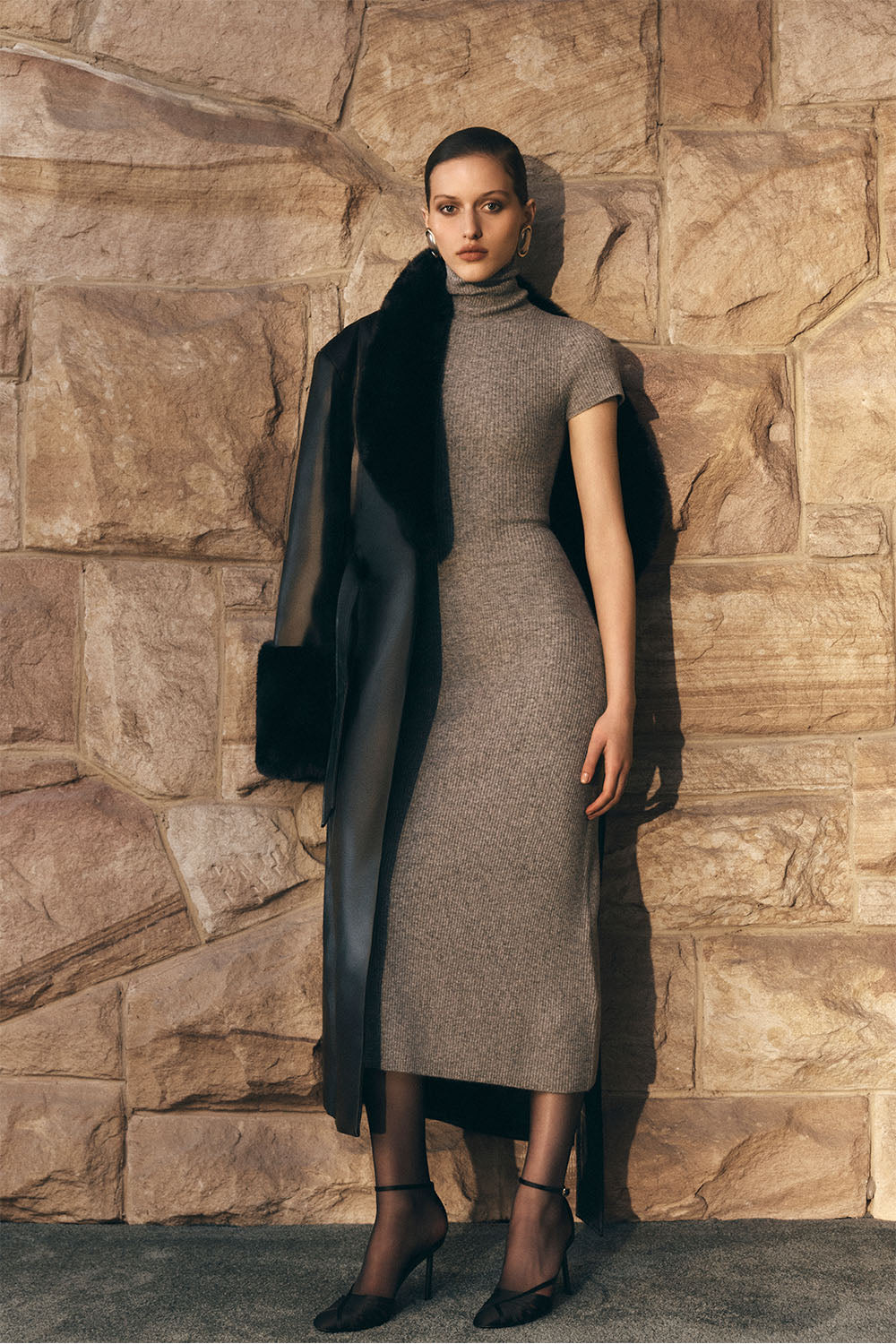 Woman wearing a grey high neck knit midi dress.